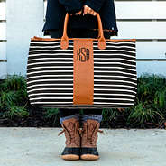 holding monogrammed carry on bag