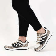 side view with leggings of monogrammed brown leopard sneakers