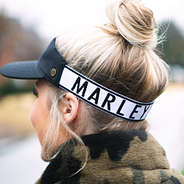 stretchy back performance visor in black and white with hair in bun
