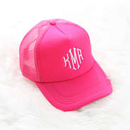 hot pink trucker hat on white rug