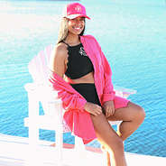 model wearing hot pink trucker at lake