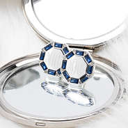 blue monogrammed cushion cut studs on compact mirror