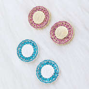 monogrammed rhinestone cluster stud earrings in pink and blue on fur rug