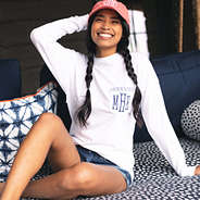 girl sitting on swing in monogrammed long sleeve fishing shirt