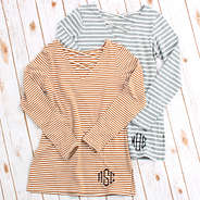 monogrammed criss cross tunics on white wood