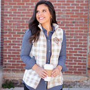 Brunette wearing chambray shirt with buffalo plaid fleece vest