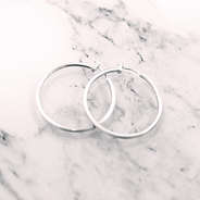 silver featherweight hoops on marble