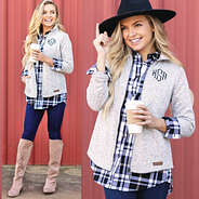 split image of monogrammed heathered jacket with monogrammed plaid layering tunic and riding boots