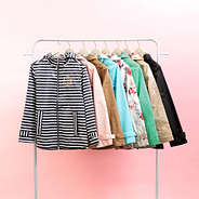 monogrammed new england rain jackets on clothing rack