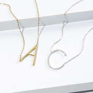 sideways initial necklace in gold and silver