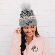 girl wearing gray leopard pom pom beanie with heather pink pullover