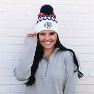 brunette wearing red, white, and blue pom pom beanie
