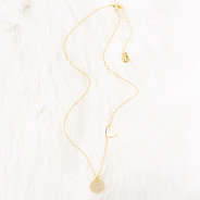 gold heart necklace on faux fur