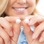 girl holding classy pearl stud earrings