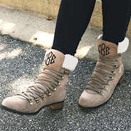 monogrammed sueded lace up boots on pavement