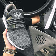 monogrammed camo sneakers in car with crossbody