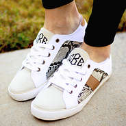 girl wearing snakeskin canvas sneakers on concrete