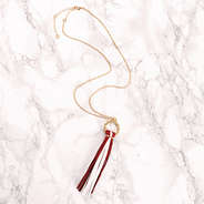circle tassel necklace on marble counter