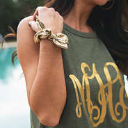 gold metallic scrunchie on wrist with monogrammed high neck tank top