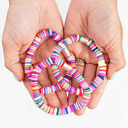 girl holding colorful rainbow beaded bracelet set