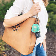 monogrammed mint airpod case linked on bag