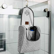 gray quilted toiletry kit hanging in bathroom