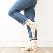 white leopard socks on feet