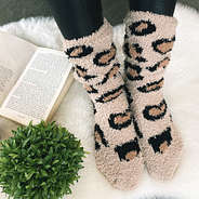 fuzzy socks with book and plant