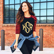 brunette wearing monogrammed buffalo plaid print raglan tunic