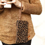 girl holding leopard clutch on wrist