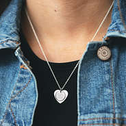 girl wearing monogrammed layered heart necklace