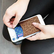 girl holding phone with metallic leopard card pocket