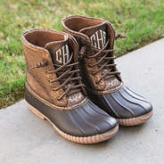 metallic leopard monogrammed duck boots on concrete