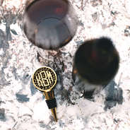 monogrammed leopard wine stopper on counter with wine