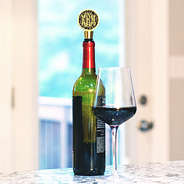 leopard print monogrammed wine stopper in wine bottle with glass of wine