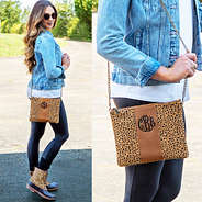 leopard dot monogrammed center stripe clutch wearing over the shoulder