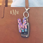 initial keychain clipped on monogrammed leather tote bag