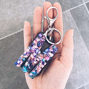 girl holding initial keychain
