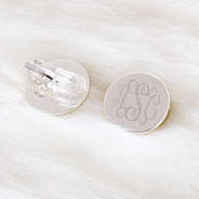 monogrammed clip on earrings on fuzzy rug