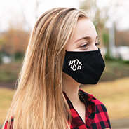 girl wearing black monogrammed face mask