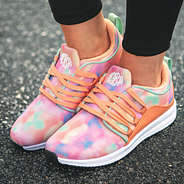 monogrammed tie dye sneakers on asphalt