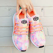 girl holding monogrammed tie dye sneakers