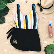 black monogrammed sarong with striped one piece bathing suit