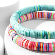 close up beaded key rings in mint and pink