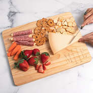 monogrammed wood cutting board with food
