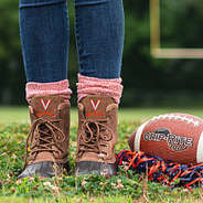 uva duck boots on football field with pom pom and football