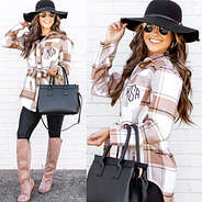 black wide brim hat with monogrammed tie waist shirt jacket and riding boots