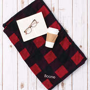 flatlay of buffalo plaid blanket with name