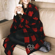 girl wrapped in buffalo plaid blanket