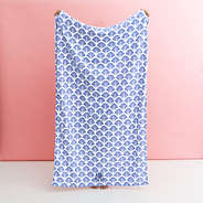 blue shells monogrammed beach towel being held up